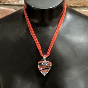 Clear glass heart pendant with red necklace